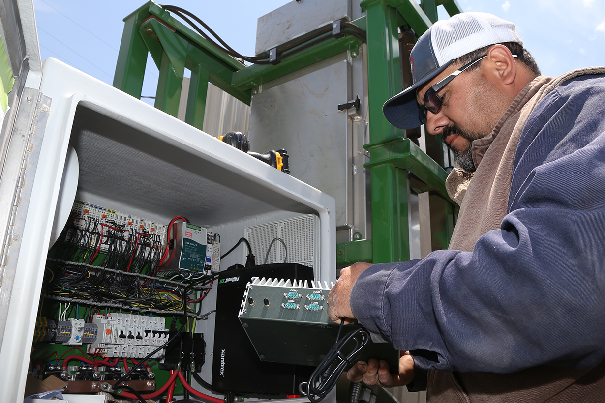 Mantis employee working on an electrical panel.